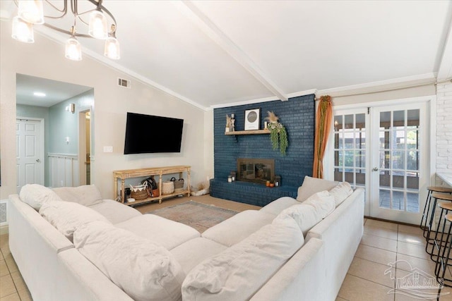 living room with french doors, lofted ceiling with beams, crown molding, light tile patterned floors, and a fireplace