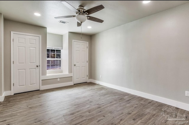 unfurnished bedroom with light hardwood / wood-style flooring and ceiling fan