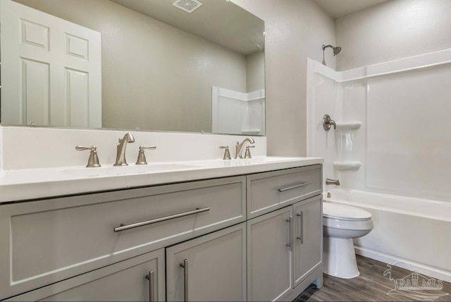 full bathroom with vanity, toilet, wood-type flooring, and bathing tub / shower combination