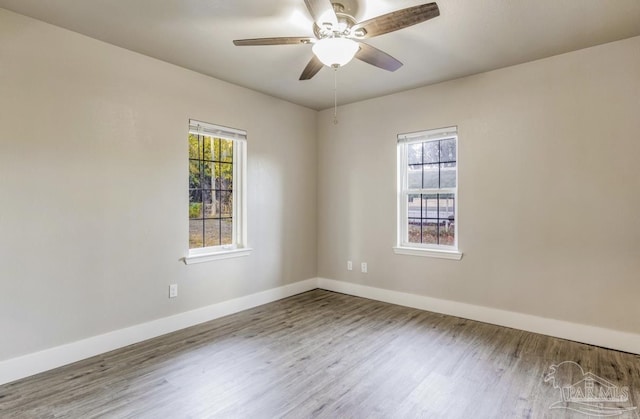 empty room featuring hardwood / wood-style floors and ceiling fan