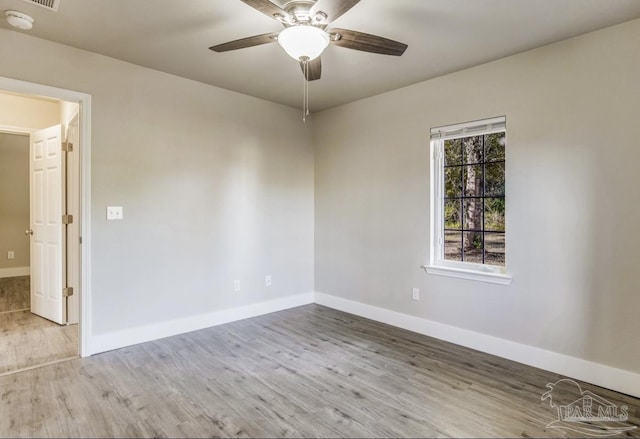 spare room with hardwood / wood-style flooring and ceiling fan