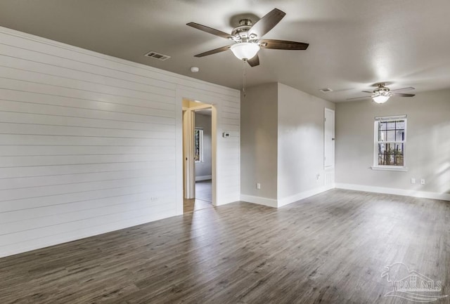 unfurnished room featuring ceiling fan and dark hardwood / wood-style flooring