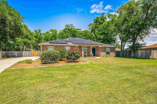 5649 Cane Syrup Cir, Pace, FL 32571 - single story home with fence, solar panels, driveway, and a front yard