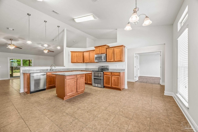 5649 Cane Syrup Cir, Pace, FL 32571 - kitchen with light countertops, brown cabinetry, stainless steel appliances, decorative light fixtures, and visible vents