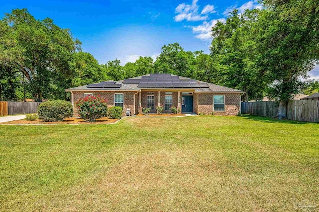 5649 Cane Syrup Cir, Pace, FL 32571 - view of front facade featuring brick siding, fence, roof mounted solar panels, and a front lawn