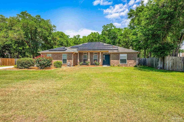 5649 Cane Syrup Cir, Pace, FL 32571 - view of front of house featuring brick siding, solar panels, a fenced backyard, and a front yard