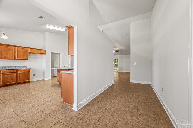 5649 Cane Syrup Cir, Pace, FL 32571 - hallway with light tile patterned floors, baseboards, visible vents, and a towering ceiling