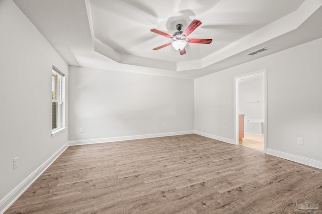 5649 Cane Syrup Cir, Pace, FL 32571 - spare room with ceiling fan, visible vents, light wood-type flooring, a raised ceiling, and baseboards