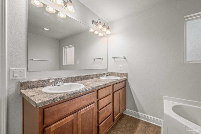 5649 Cane Syrup Cir, Pace, FL 32571 - full bathroom featuring baseboards, double vanity, tile patterned floors, and a sink