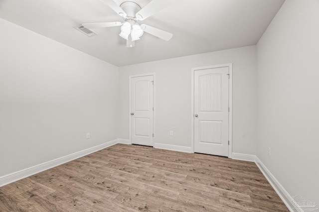 5649 Cane Syrup Cir, Pace, FL 32571 - unfurnished bedroom featuring visible vents, a ceiling fan, baseboards, and wood finished floors