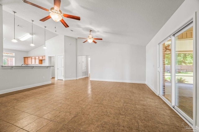 5649 Cane Syrup Cir, Pace, FL 32571 - unfurnished living room with baseboards, a ceiling fan, and high vaulted ceiling