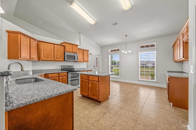 5649 Cane Syrup Cir, Pace, FL 32571 - kitchen featuring a kitchen island, brown cabinets, a sink, appliances with stainless steel finishes, and vaulted ceiling