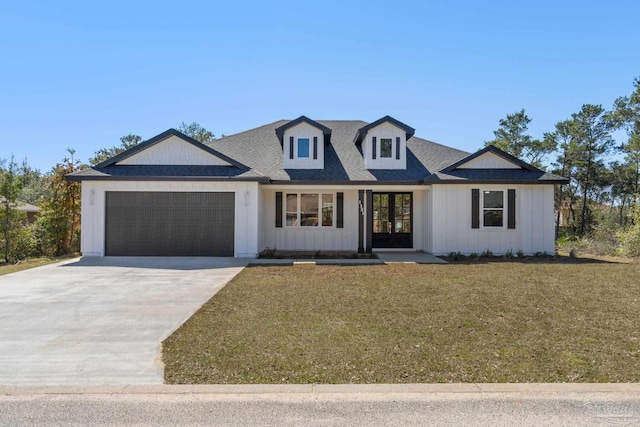 view of front of house featuring a garage and a front lawn