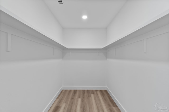 walk in closet featuring light hardwood / wood-style flooring