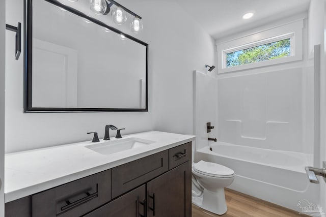 full bathroom featuring toilet, vanity, shower / tub combination, and wood-type flooring