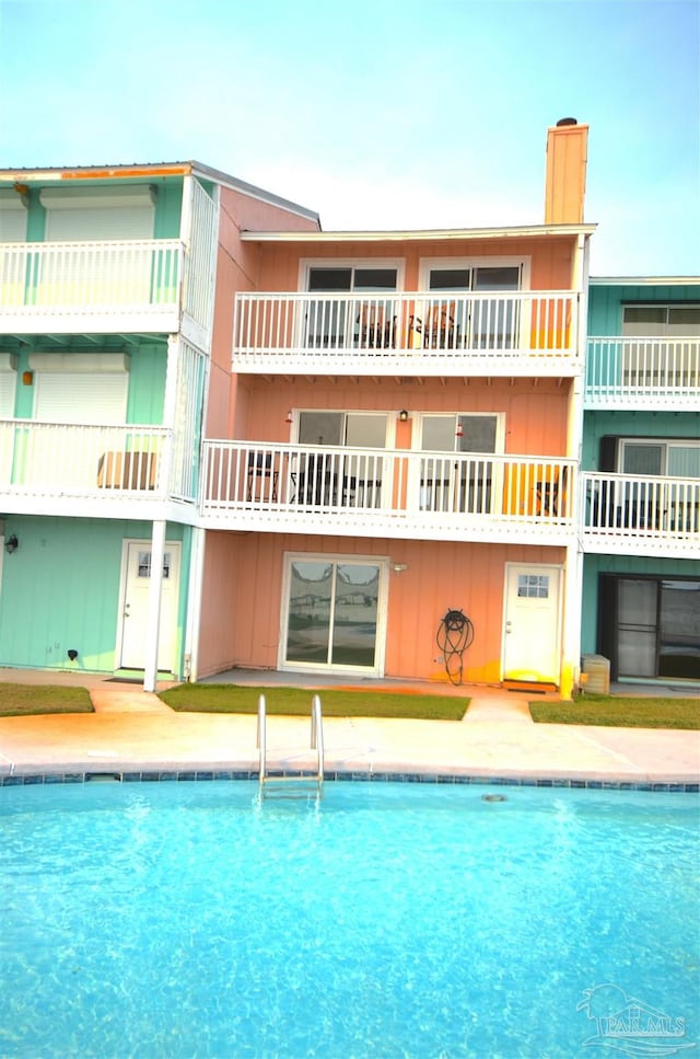 community pool with a patio area