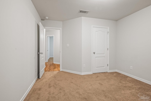 unfurnished bedroom featuring baseboards, visible vents, and carpet flooring