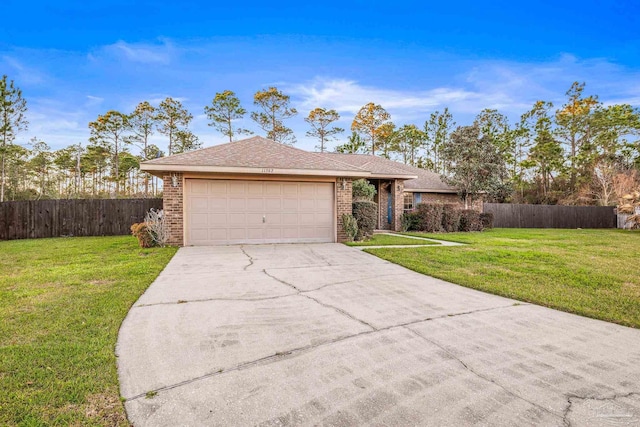 single story home with driveway, brick siding, an attached garage, and a front yard