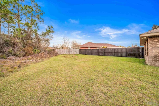 view of yard with a fenced backyard