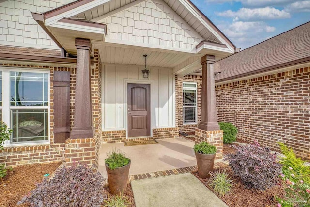 view of exterior entry with a porch