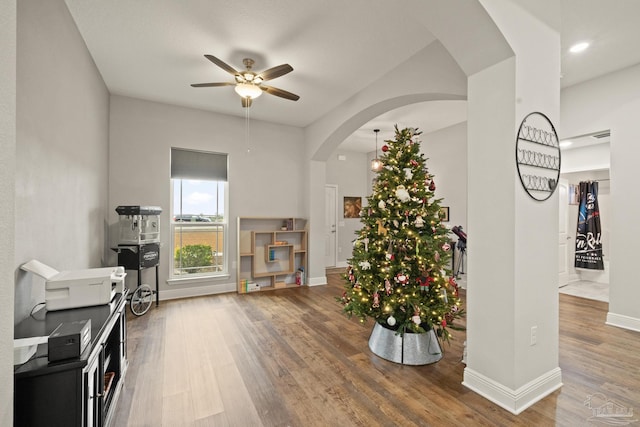 interior space with wood-type flooring and ceiling fan