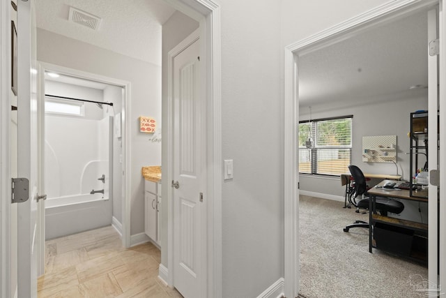 bathroom with shower / washtub combination and a textured ceiling