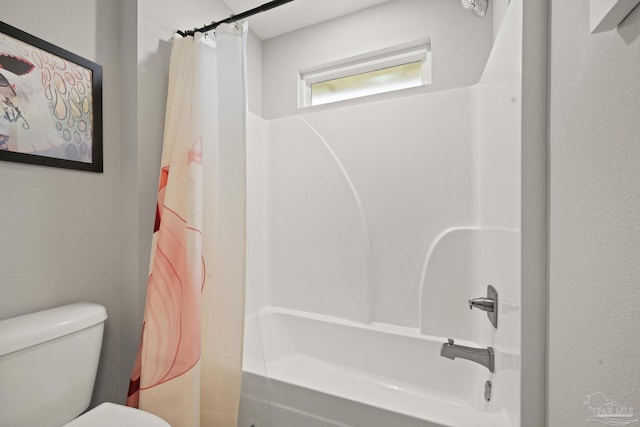 bathroom with shower / bath combo with shower curtain and toilet