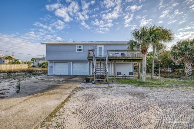 view of front of house with a wooden deck and a garage