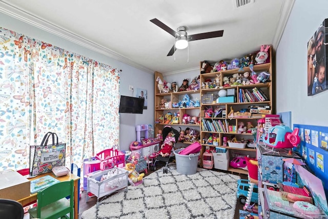 rec room featuring crown molding, ceiling fan, and wood-type flooring