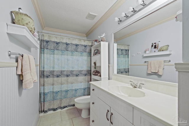 bathroom with tile patterned flooring, ornamental molding, vanity, toilet, and a textured ceiling