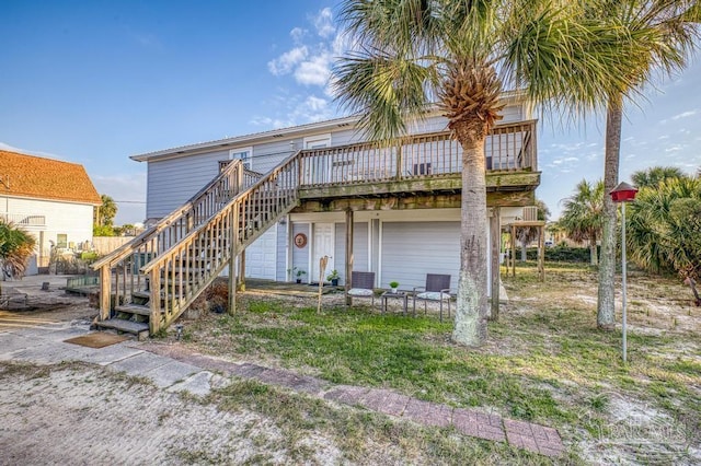 back of house with a deck