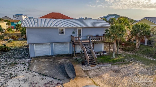 view of front of property with a garage and a deck