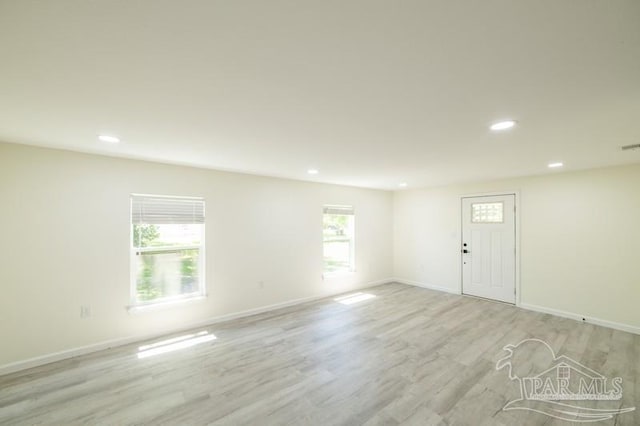 interior space with light wood-style floors, baseboards, and recessed lighting