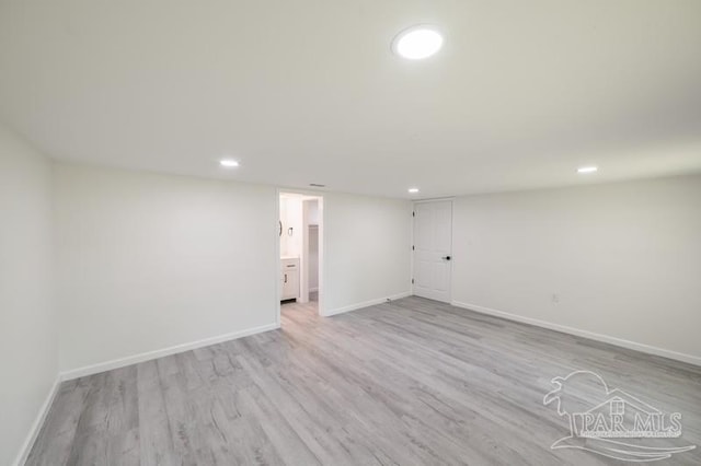 finished basement featuring recessed lighting, light wood-style flooring, and baseboards