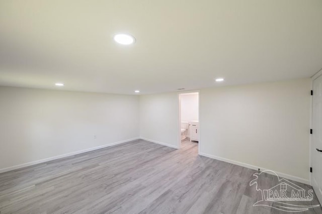finished below grade area featuring baseboards, recessed lighting, and light wood finished floors