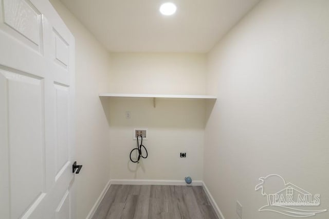 laundry room with light wood-type flooring, hookup for an electric dryer, baseboards, and laundry area