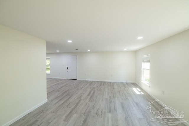 unfurnished room featuring baseboards, recessed lighting, and light wood finished floors