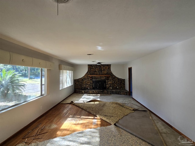 unfurnished living room featuring a fireplace and wood-type flooring