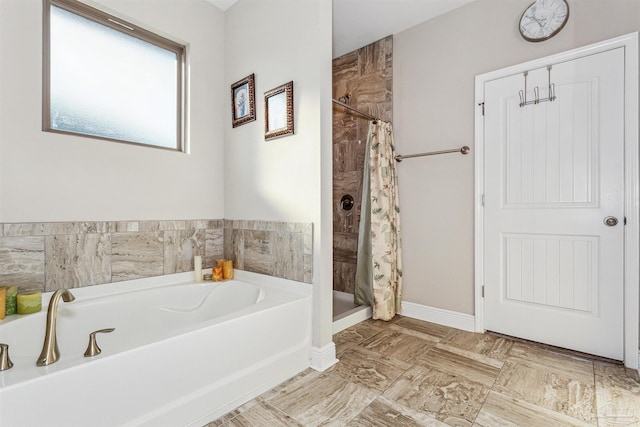 bathroom featuring shower with separate bathtub