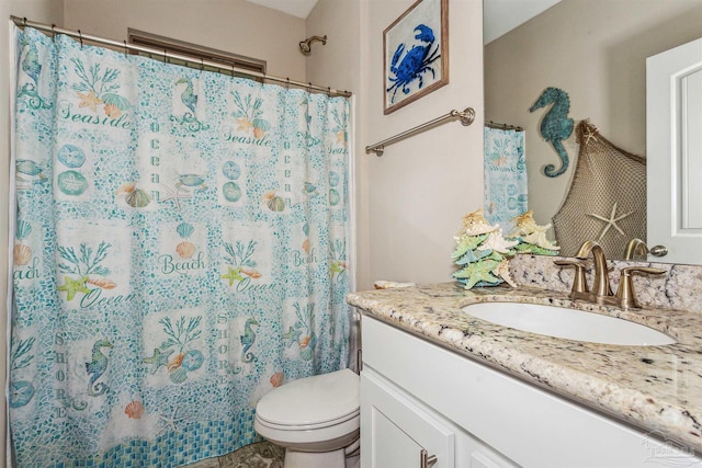 bathroom featuring walk in shower, vanity, and toilet