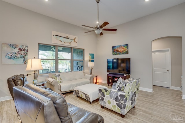 living room featuring ceiling fan and light hardwood / wood-style floors