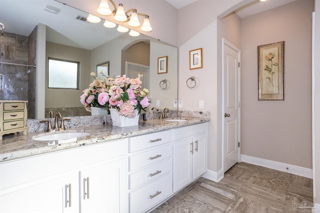 bathroom featuring walk in shower and vanity