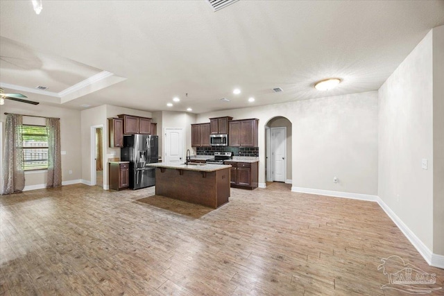 6372 Ladera Trl, Pace, FL 32571 - kitchen with stainless steel appliances, open floor plan, a sink, arched walkways, and recessed lighting