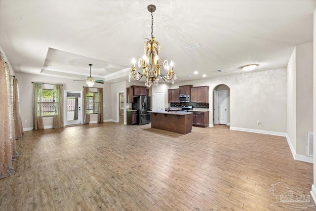 6372 Ladera Trl, Pace, FL 32571 - kitchen with open floor plan, appliances with stainless steel finishes, light wood-style floors, arched walkways, and recessed lighting