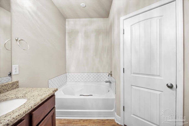 6372 Ladera Trl, Pace, FL 32571 - full bath featuring vanity, a garden tub, and wood finished floors