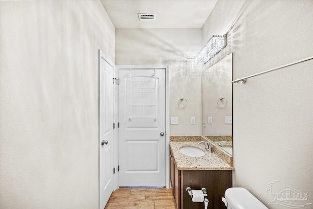 6372 Ladera Trl, Pace, FL 32571 - bathroom with vanity, toilet, and wood finished floors