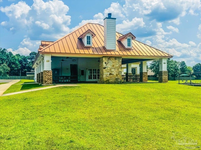 6372 Ladera Trl, Pace, FL 32571 - back of property with a standing seam roof, a chimney, brick siding, metal roof, and a ceiling fan