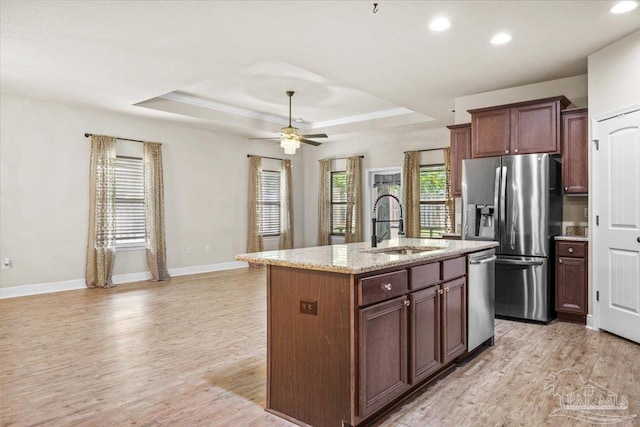 6372 Ladera Trl, Pace, FL 32571 - kitchen featuring appliances with stainless steel finishes, a tray ceiling, light wood-style flooring, recessed lighting, and a ceiling fan