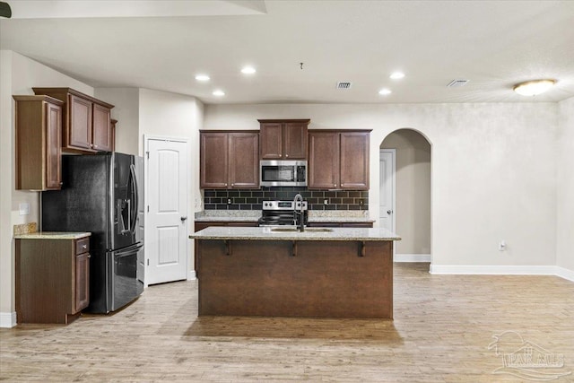 6372 Ladera Trl, Pace, FL 32571 - kitchen with stainless steel appliances, a sink, backsplash, light wood-type flooring, and recessed lighting