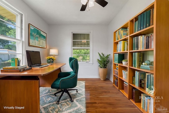 office space featuring ceiling fan, baseboards, and wood finished floors